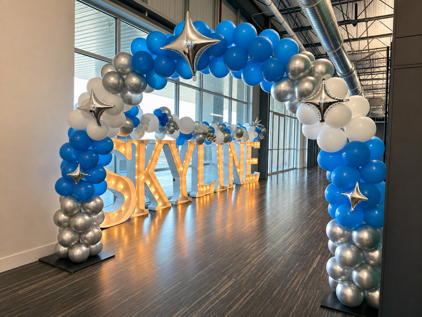 Blue and silver balloons for entry into a large banquet room.