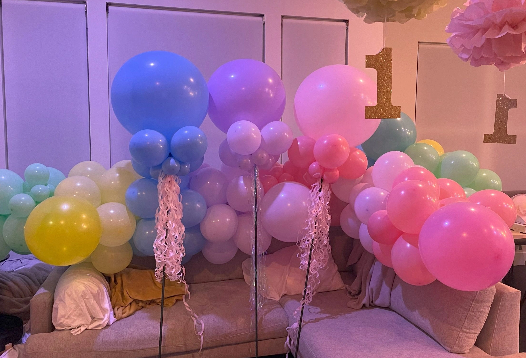 Pastel balloon clusters for a first birthday