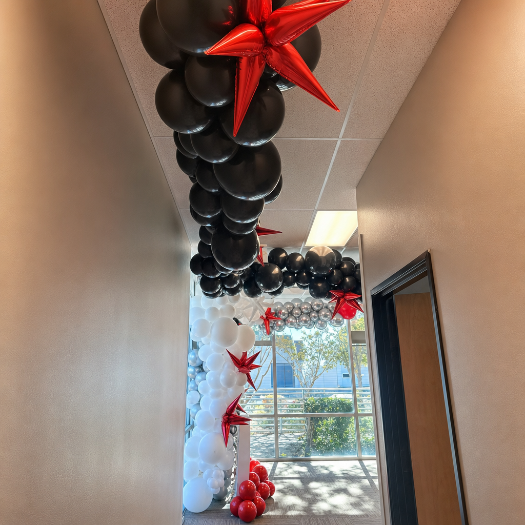 Black, white, and red star balloon hallway installation